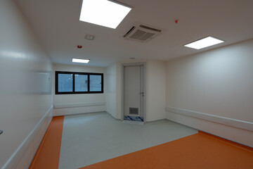 Vibrant empty hospital rooms with modern orange and grey flooring, radiating a calming yet professional atmosphere