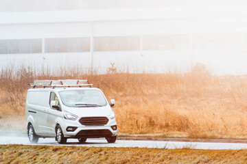 Professional work van with tools driving in business