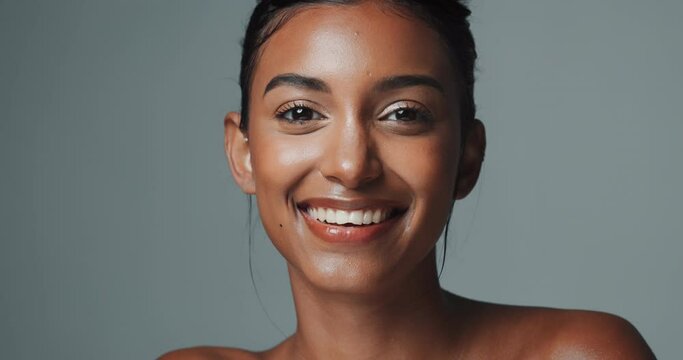 Woman, portrait and makeup with smile for beauty or skincare, confidence or studio background. Female model, face or cosmetics on backdrop with happiness for dermatology, aesthetics for wellness
