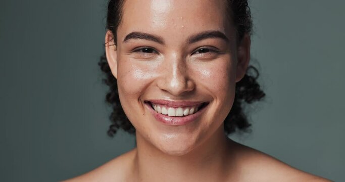 Woman, face and beauty or skincare in studio, smile and acne treatment for dermatology wellness. Glowing, clean and routine transformation, background and confident for natural breakout prevention