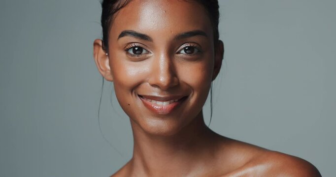 Female model, studio background and topless with smile for beauty or skincare, confidence or results. Indian woman, face or cosmetics on backdrop with happiness for dermatology, shirtless with makeup