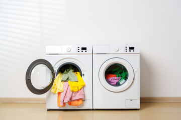 White Washing Machine With Colorful Clothes Hanging Out