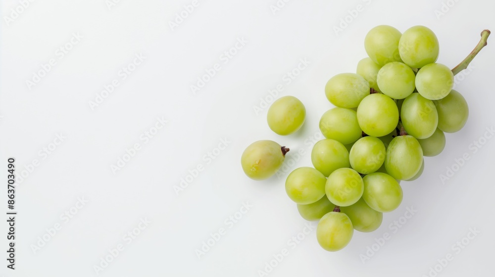 Wall mural Green grapes on white background, top view