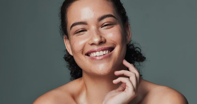 Beauty, face and hands with woman laughing in studio isolated on gray background for skincare. Acne scars, funny and natural with portrait of happy model touching skin for cosmetic satisfaction