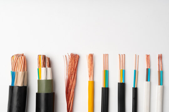 Various Electrical Wires With Exposed Copper Strands on White Background