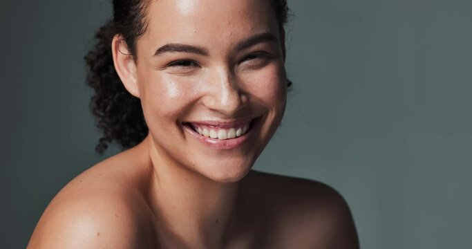 Woman, face and beauty or happy in studio, smile and acne treatment for dermatology wellness. Glowing, skincare and routine transformation, background and confident for natural breakout prevention
