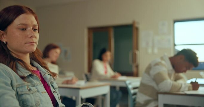 Student, girl and struggling in exam with anxiety, stress and emotion in classroom, school or education. Female person, giving up and frustrated in learning, development with overwhelmed by mistake