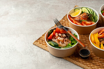 Fresh poke bowl on straw mat close up