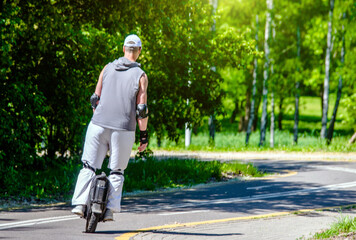 guy on a monowheel ride through the city Park
