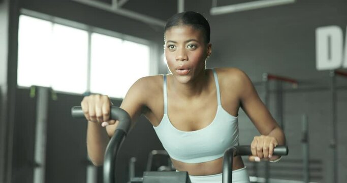 Gym, woman and group on bike, exercise and fitness, energy and machine for cardio in morning and active. Action, moving and workout of people, training and wellness with cycling, speed and spin class