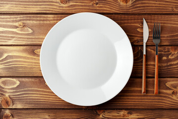 White ceramic tableware on wooden background top view