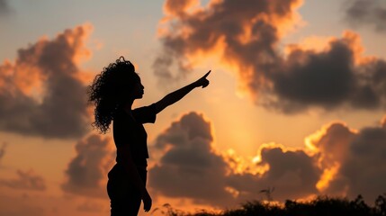 silhouette of woman pointing in sky with better contrast and details for impactful image.