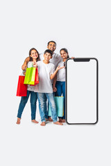 asian Indian family promoting sale offer standing with big tall smartphone cutout