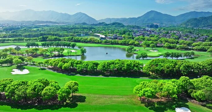 Green golf course and mountain range natural scenery