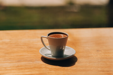 Closeup of coffee cup on table in empty corporate conference room before business meeting in office