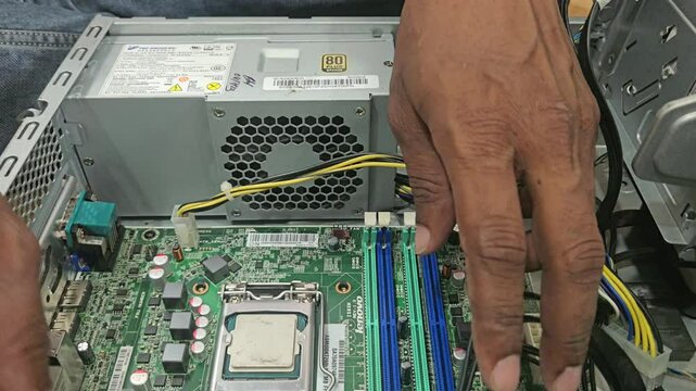 Electronics repair and maintenance service. technician working with computer parts.