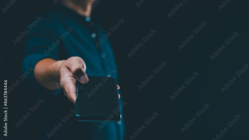 Poster a trendy young man shows his smartphone, displaying a blank screen with copy space for adding text.