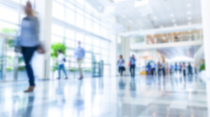 Fototapeta premium A soft-focus photo of a hospital lobby with people walking by, creating a busy yet calm atmosphere
