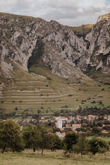 The village of Rimetea under the Piatra Secuiului mountain. White Church Tower stands out. Meadow...