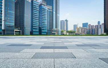 Fototapeta na wymiar Empty square facing modern business buildings in big city