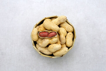 Roasted peanuts in shell on grey background.