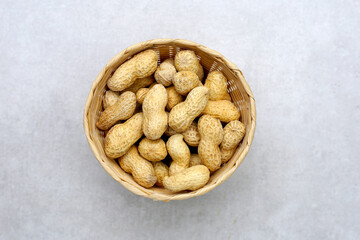 Roasted peanuts in shell on grey background.