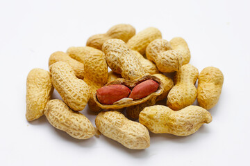 Roasted peanuts in shell on white background.