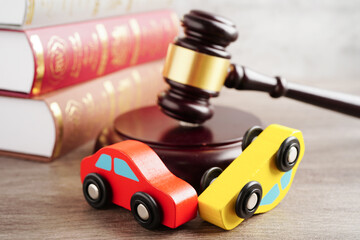 Car accident lawsuit and insurance, Judge hammer with car model.