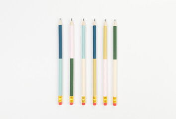Top view of colorful pencils on white background. School, office, art wallpaper. Flat lay, copy space.