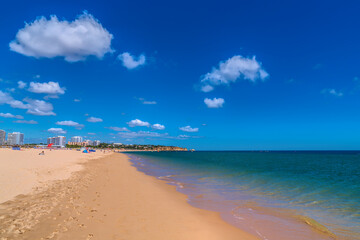 Alvor Portugal beautiful sandy beach southern Algarve with clear blue sea and sky