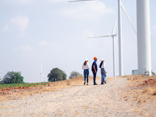 Group of engineers and architects working on the basis of a wind turbine Inspect the structure with...