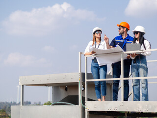 Group of engineers and architects working on the basis of a wind turbine Inspect the structure with...