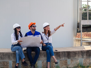 Group of engineers and architects working on the basis of a wind turbine Inspect the structure with...