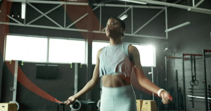 Jump, skipping rope or black woman with fitness for body health, training or cardio exercise challenge. Development, agility or African girl athlete in gym with wellness, mobility workout or energy