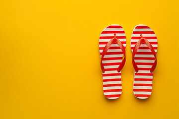 Red and White Striped Flip Flops on a Yellow Background