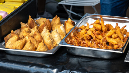 Delicious assortment of fried seafood and dumplings, featuring crispy shrimp and golden samosas