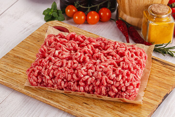 Raw minced beef meat over board