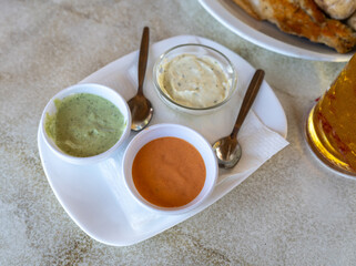 Red mojo, green mojo, garlic sauce. Traditional Tenerife dipping sauces, local cuisine, condiment tray