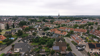 Obraz premium Aerial shot of houses with solar panels on roof in a street in a residential area neighborhood in Steenwijk, Overijssel, The Netherlands.