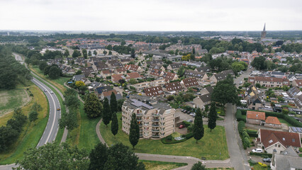 Fototapeta premium Aerial shot of apartment building flat 'De Tichelkamp' with solar panels on roof in a street in a residential area neighborhood in Steenwijk, Overijssel, The Netherlands.