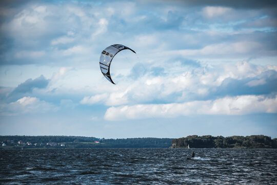 Minsk, Belarus - June 15, 2014. Kitesurfing. One kite in the sky and man on water. The concept of sports, health, recreation. Holidays on nature. Activity lifestyle. Windy weather. Lake entertainment