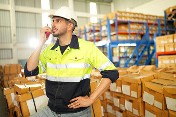 Warehouse worker working in warehouse storage. Foreman or worker work at factory site check up...