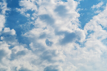 Light clouds with sun rays against the background of a blue clear sky with dusky air space. Natural weather phenomena, changes in the upper atmosphere. Basic elements of nature, element of Air