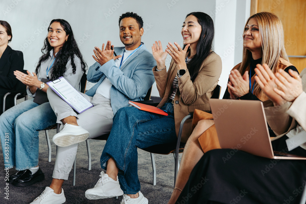 Wall mural Engaged coworkers clapping during a corporate event