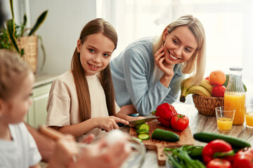 Mother and daughter cooking together in a bright kitchen, enjoying creating meals side by side