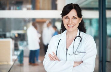 Portrait, happy woman or doctor with arms crossed in clinic for healthcare services, career or medicine. Proud, medical professional or confident physician with smile at wellness hospital for nursing