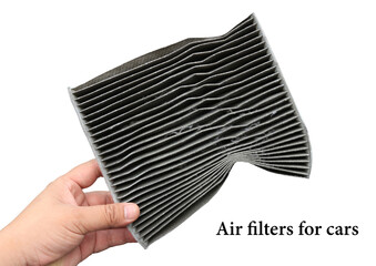Car air filter on a white background held or held by the left hand, the dust that sticks like this...