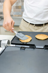 Young smiling happy confident  baker man  in the kitchen. Process cooking food concept. 
