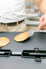 Young smiling happy confident  baker man  in the kitchen. Process cooking food concept. 