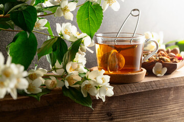 Cup of jasmine tea and fresh jasmine flowers.